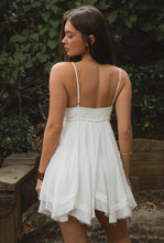 Load image into Gallery viewer, Woman wearing a white dress with thin straps in an outdoor setting