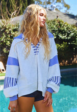 Load image into Gallery viewer, Woman wearing a blue and white striped hoodie by a pool