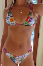 Load image into Gallery viewer, Person wearing a colorful floral bikini standing indoors.