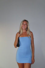 Load image into Gallery viewer, Woman wearing a blue dress against a plain background