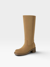 Load image into Gallery viewer, A single mid-calf boot in tan suede or nubuck, shown from a three-quarter side angle against a clean, light gray studio background.