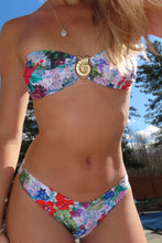 Load image into Gallery viewer, Person wearing a colorful floral bikini with a blurred background