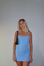 Load image into Gallery viewer, Woman wearing a light blue dress against a plain background