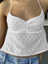 Load image into Gallery viewer, A white halter open back crop top paired with blue denim shorts.