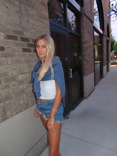 Load image into Gallery viewer, Woman lying on a sidewalk with a reflective surface behind her