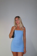 Load image into Gallery viewer, Woman wearing a blue dress against a plain background