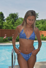 Load image into Gallery viewer, A woman standing by a pool wearing a blue and white geometric patterned bikini.