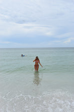 Load image into Gallery viewer, Person standing in shallow water with a clear blue sky above