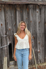 Load image into Gallery viewer, Woman standing on a wooden staircase wearing a white top and blue jeans.
