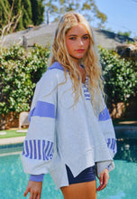 Load image into Gallery viewer, Woman wearing a gray and blue jacket by a pool