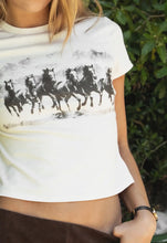 Load image into Gallery viewer, White t-shirt with black horse graphic worn by a person outdoors