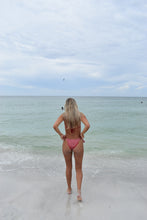 Load image into Gallery viewer, Person in a pink bikini standing in shallow water with a clear blue sky.