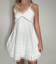 Load image into Gallery viewer, White lace-trimmed dress worn by a person on a plain background