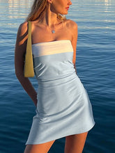 Load image into Gallery viewer, Woman wearing a strapless dress with color-block design by the water