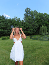 Load image into Gallery viewer, Woman in a white dress standing on grass with trees in the background