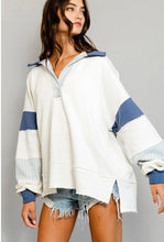 Load image into Gallery viewer, A woman wearing a striped blue pullover with a grey or white base color, paired with denim shorts.