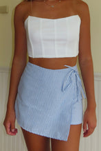 Load image into Gallery viewer, Person wearing a white strapless top and blue striped skirt against a neutral background