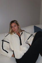 Load image into Gallery viewer, Woman wearing a white outfit with black accents against a plain background