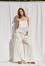 Load image into Gallery viewer, Woman wearing a white outfit standing against a white curtain
