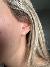 Load image into Gallery viewer, Close-up of an ear with a diamond earring against a neutral background
