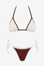 Load image into Gallery viewer, A two-piece bikini set featuring a white fabric with black polka dots and contrasting dark brown trim, shown in a top and bottom view against a light gray background.

