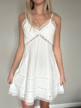Load image into Gallery viewer, White lace dress being modeled against a neutral background
