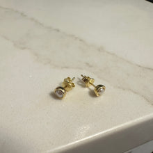 Load image into Gallery viewer, Gold stud earrings on a marble surface
