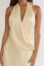 Load image into Gallery viewer, Butter yellow satin halter maxi dress with draped surplice neckline, open tie-back design, and elegant floor-length silhouette for weddings and formal events.
