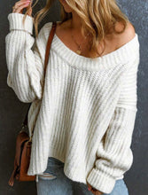 Load image into Gallery viewer, Person wearing a white chunky knit sweater against a dark background
