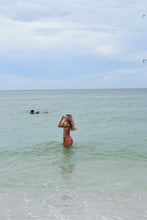 Load image into Gallery viewer, Person standing in clear water with a blue sky above
