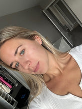 Load image into Gallery viewer, Woman with blonde hair and blue eyes wearing a white top in an indoor setting.
