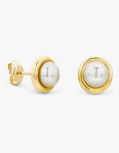 Load image into Gallery viewer, Gold earrings with white pearls on a light gray background
