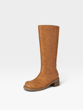 Load image into Gallery viewer, A single knee-high boot in a warm tan or camel faux-leather material, shown from a three-quarters angle against a clean white studio background.
