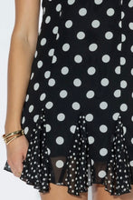 Load image into Gallery viewer, Black and white polka dot mini dress with adjustable spaghetti straps, fitted bodice, ruffle hem, and lightweight flowy fabric for summer.
