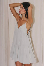 Load image into Gallery viewer, Light sage green babydoll mini dress with adjustable spaghetti straps, lace trim, side tie details, and a flowy tiered skirt for summer.
