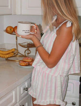 Load image into Gallery viewer, A woman in a pink and white striped romper stands in a kitchen holding a white mug that reads 'you are my favorite'.
