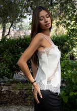 Load image into Gallery viewer, Woman wearing a white lace top outdoors with greenery in the background
