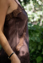 Load image into Gallery viewer, Close-up of a person wearing a brown lace-trimmed garment with a blurred green background
