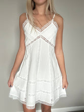 Load image into Gallery viewer, White lace dress being modeled against a neutral background
