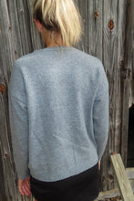 Load image into Gallery viewer, Person wearing a gray sweater on a wooden deck
