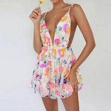 Load image into Gallery viewer, A woman wearing a white and pink floral sequin dress with gold straps.
