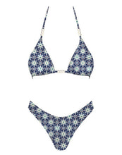 Load image into Gallery viewer, A bikini set with a kaleidoscopic floral print in deep navy and icy white tones, featuring a triangle top detailed with pearl-like beads along the straps and center.
