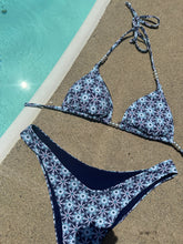 Load image into Gallery viewer, Triangular bikini set with geometric pattern on sand by pool.

