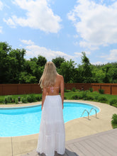 Load image into Gallery viewer, Person holding an inflatable pool float by a pool with trees and blue sky in the background
