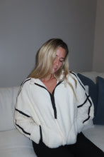 Load image into Gallery viewer, Person wearing a white scarf with black patterns on a plain background
