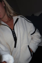 Load image into Gallery viewer, Person wearing a white robe with black trim in a dark setting
